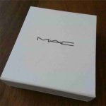 White textured rigid box with centered branding.