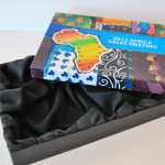 Stacked large-format black rigid boxes featuring tonal black silkscreened branding.