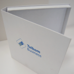 White book-style rigid box with blue-printed branding on the front panel.