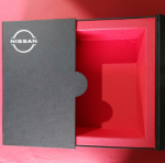 Interior view of a black rigid box with a vibrant red custom-fit insert tray.