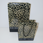 Large and small paper bags featuring a high-gloss leopard print pattern and black cord handles.