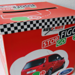 Large red printed entry box with a top slot for competition entries and checkered patterns.