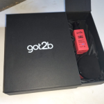Open black box featuring a product nestled in crushed black fabric lining.