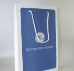 White matte-finish paper bag featuring a single-color blue silkscreen logo and white cord handles