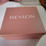 Square dusty pink rigid box with high-precision white branding.