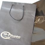 Comparison of a matte-finish black bag with silver foil stamping and a high-gloss black bag with white branding.