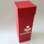 Tall red rigid box with a cream-colored foiled logo for agricultural sector gifting.