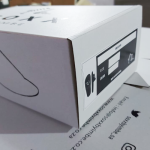 White E-Flute box with black silk-screened typography and graphic icons.
