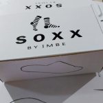 White E-Flute box with black silk-screened typography and graphic icons.