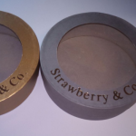 Circular rigid lids in gold and grey with large transparent PVC viewing windows.