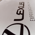Close-up of high-build black UV DTF branding on a smooth white substrate.