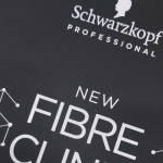 Technical detail of white silk-screened typography on a black substrate.