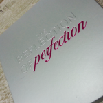 Pink foil combined with clear debossing on a silver metallic substrate.