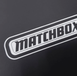 White silk-screened branding on a heavily textured black paper substrate.