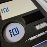 Multi-item promotional kits (tumblers, notebooks, pens) housed in high-density foam.