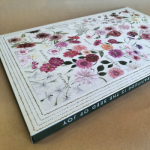 Large format flat-top box with full-bleed floral print and perforated window advent calendar cut-outs