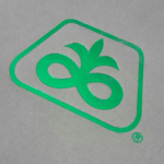 Close up of Green Foil on Grey Textured Paper