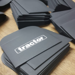 Stack of minimalist black card envelopes with white silk-screened logos.